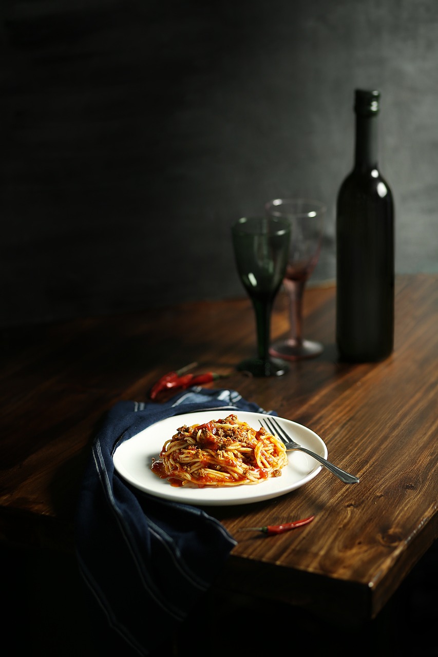 Wine and Pasta A plate of pasta and a bottle of wine.